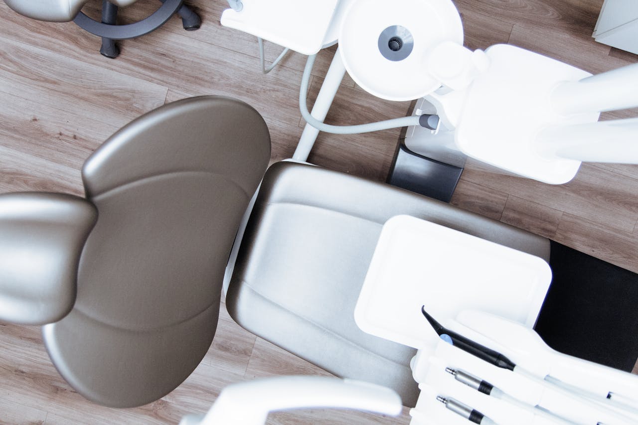 About High-angle view of a modern dental chair and equipment setup in a professional clinic.